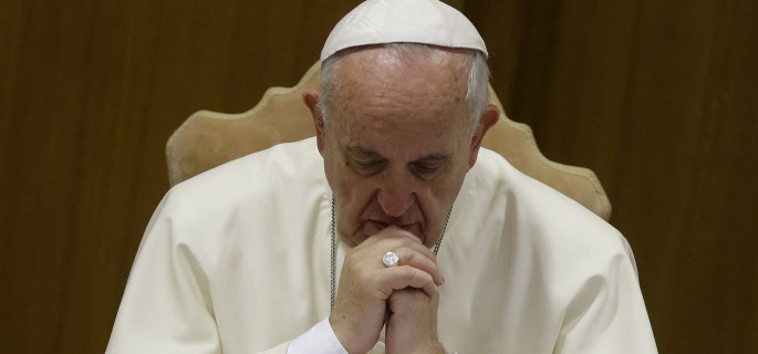 Pope Francis prays as he opens the morning session of a two-week synod on family issues at the Vatican, Saturday, Oct. 18, 2014. (AP Photo/Andrew Medichini)